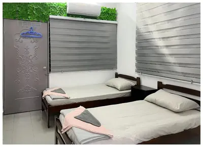 a room with two beds and a window at ✩ 23 HOUSE ✩ 23号 复古老宅 ✩ Vintage Homestay in Butterworth