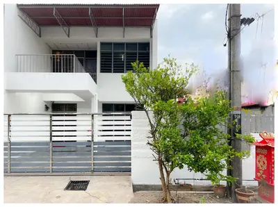 a white house with a tree in front of it at ✩ 23 HOUSE ✩ 23号 复古老宅 ✩ Vintage Homestay in Butterworth