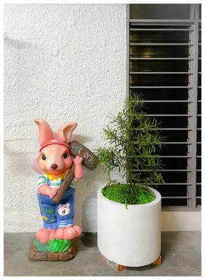 a statue of a pig standing next to a plant at ✩ 23 HOUSE ✩ 23号 复古老宅 ✩ Vintage Homestay in Butterworth