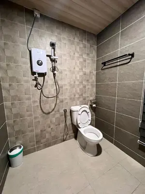 a bathroom with a toilet and a shower at BEATRIX HOTEL in Brinchang