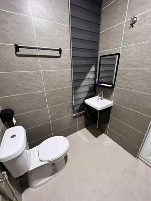 a bathroom with a toilet and a sink at BEATRIX HOTEL in Brinchang