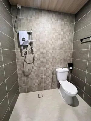 a bathroom with a toilet and a shower at BEATRIX HOTEL in Brinchang