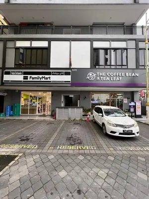 a car parked in a parking lot in front of a building at BEATRIX HOTEL in Brinchang