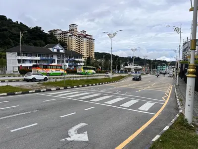 an empty street with cars and buildings on it at BEATRIX HOTEL in Brinchang