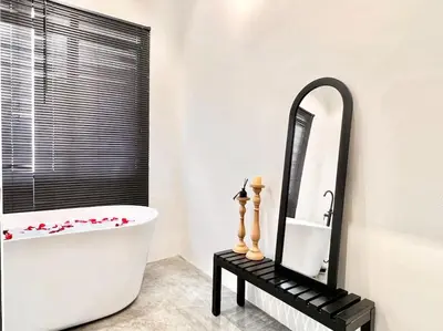 a bathroom with a white tub and a mirror at Studio S Conceptual Homestay Station 18 - Ipoh in Ipoh