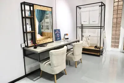 a desk with two chairs and a mirror in a room at Studio S Conceptual Homestay Station 18 - Ipoh in Ipoh