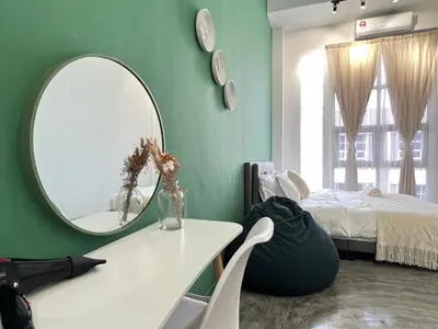 a room with a mirror and a table and a bed at Studio S Conceptual Homestay Station 18 - Ipoh in Ipoh