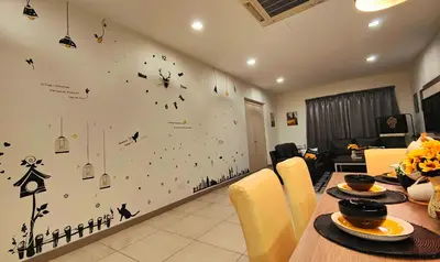a dining room with a table with a clock on the wall at Ipoh City Modern Homestay Octagon 5-6 pax Apartment Suite Free Parking by City Home Empire in Ipoh