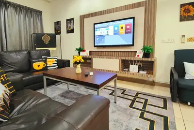 a living room with leather furniture and a flat screen tv at Ipoh City Modern Homestay Octagon 5-6 pax Apartment Suite Free Parking by City Home Empire in Ipoh