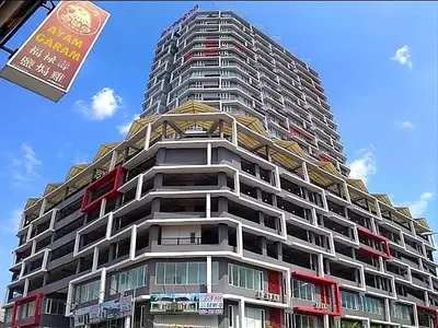 a tall building with a sign in front of it at Ipoh City Modern Homestay Octagon 5-6 pax Apartment Suite Free Parking by City Home Empire in Ipoh