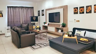 a living room with leather furniture and a television at Ipoh City Modern Homestay Octagon 5-6 pax Apartment Suite Free Parking by City Home Empire in Ipoh