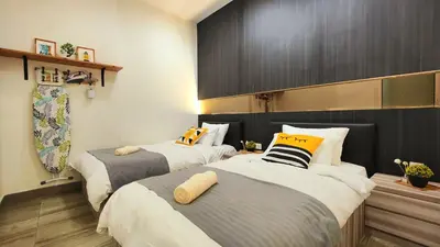 a bedroom with two beds with pillows on them at Ipoh City Modern Homestay Octagon 5-6 pax Apartment Suite Free Parking by City Home Empire in Ipoh