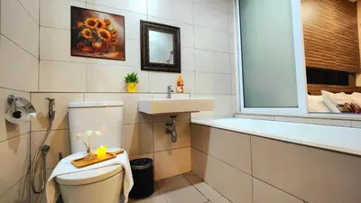 a bathroom with a toilet and a sink and a bath tub at Ipoh City Modern Homestay Octagon 5-6 pax Apartment Suite Free Parking by City Home Empire in Ipoh