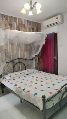 a bedroom with a bed with stars on it at Comfy Home Near to Penang Hill in Ayer Itam