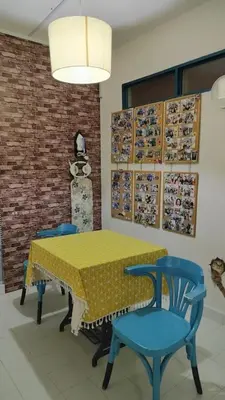 a dining room with a yellow table and blue chairs at Comfy Home Near to Penang Hill in Ayer Itam