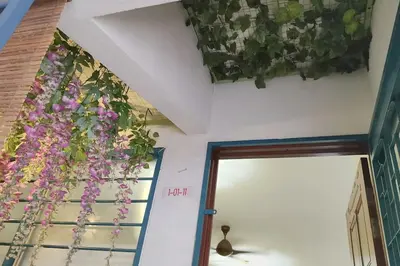 a room with flowers hanging from the ceiling at Comfy Home Near to Penang Hill in Ayer Itam