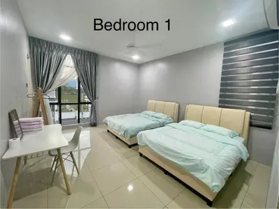 two beds in a room with a table and a desk at 4 Bedroom 4 PRIVATE BATHROOM 4B12B 5 min City Center in Ipoh
