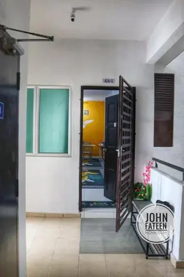 a hallway with a door open to a room at lumut manjung homestay john faten in Lumut