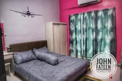 a room with a couch and a plane on the wall at lumut manjung homestay john faten in Lumut