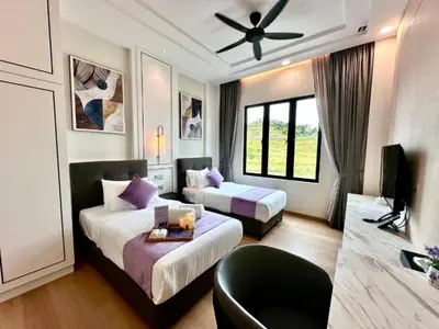 a hotel room with two beds and a ceiling fan at Cameron Lavender Mansion by PLAY in Brinchang
