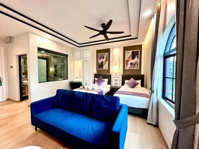 a living room with a couch and two beds at Cameron Lavender Mansion by PLAY in Brinchang