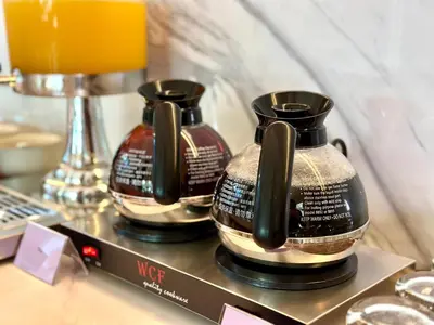two vases sitting on a shelf with a drink at Cameron Lavender Mansion by PLAY in Brinchang