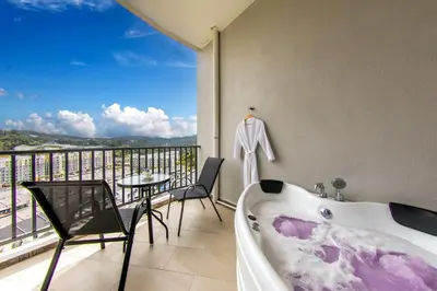 a bath tub in a room with a balcony at Cameron Lavender Mansion by PLAY in Brinchang