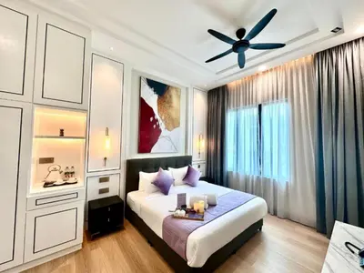a bedroom with a bed and a ceiling fan at Cameron Lavender Mansion by PLAY in Brinchang
