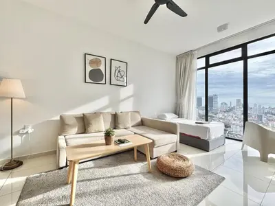 a white living room with a couch and a bed at Beacon Executive Suites #Warmth suite #Rooftop pool #Georgetown in George Town