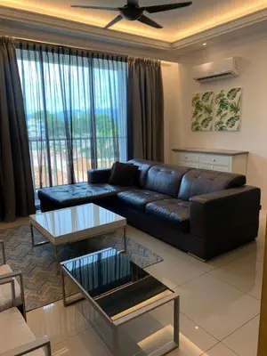a living room with a leather couch and a table at Aiera Homestay @ Meru Casa Kayangan in Ipoh