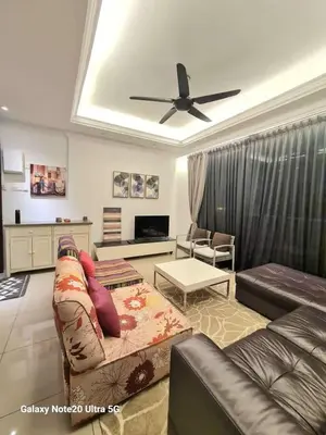 a living room with a couch and a ceiling fan at Aiera Homestay @ Meru Casa Kayangan in Ipoh