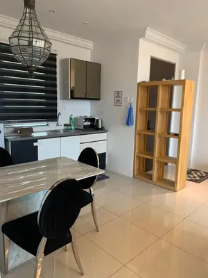 a kitchen with a table and chairs in a room at Aiera Homestay @ Meru Casa Kayangan in Ipoh