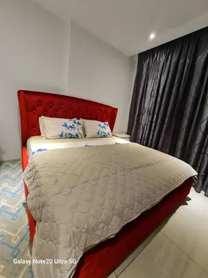 a bedroom with a large bed with a red headboard at Aiera Homestay @ Meru Casa Kayangan in Ipoh