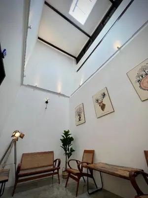 a room with chairs and a table and a skylight at DoSomething Guest House 5 in Ipoh