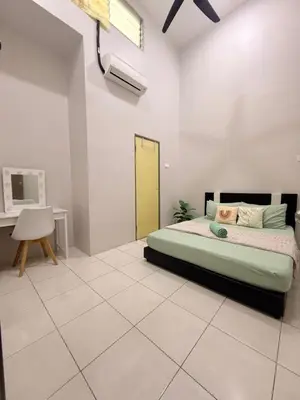 a bedroom with a bed and a desk in it at QM_Homestay Bagan Serai in Bagan Serai
