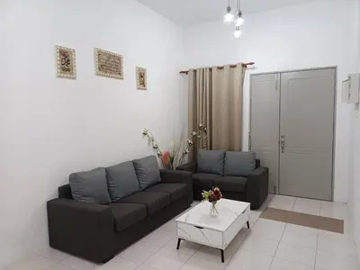 a living room with a couch and a table at QM_Homestay Bagan Serai in Bagan Serai