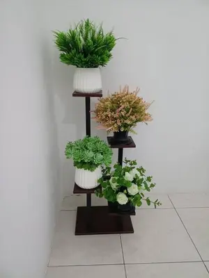 a shelf with three potted plants on it at QM_Homestay Bagan Serai in Bagan Serai