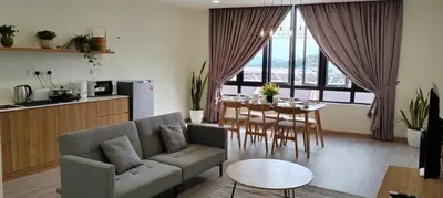 a living room with a couch and a table at Secret Garden @ Cameron Centrum in Brinchang