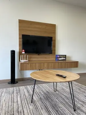 a living room with a coffee table and a flat screen tv at Secret Garden @ Cameron Centrum in Brinchang