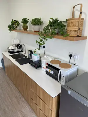 a kitchen with a counter top with a microwave at Secret Garden @ Cameron Centrum in Brinchang