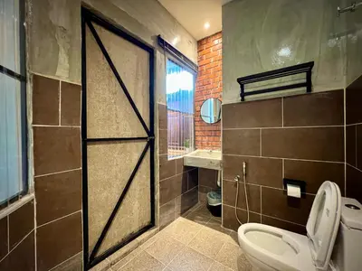 a bathroom with a door with a toilet and a window at DoSomething Guest House 3 in Ipoh