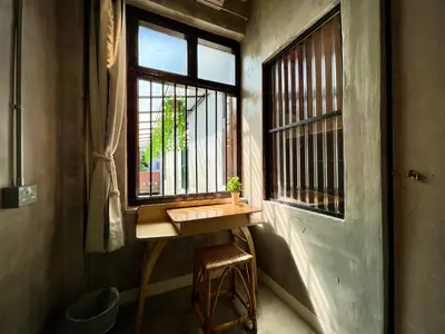 a small table in a room with a window at DoSomething Guest House 3 in Ipoh
