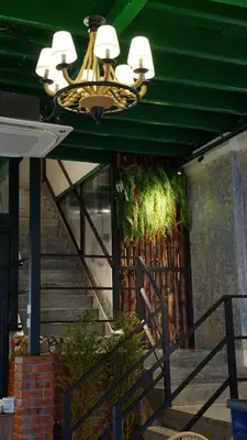 a staircase with a chandelier in a building with a staircase at DoSomething Guest House 3 in Ipoh