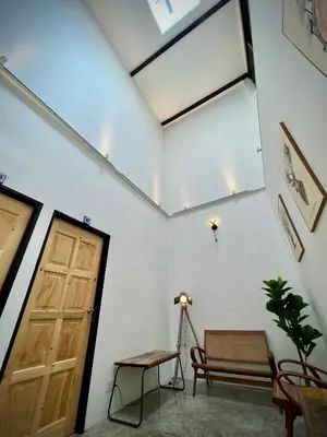 a room with a door and a bench and a table at DoSomething Guest House 8 in Ipoh