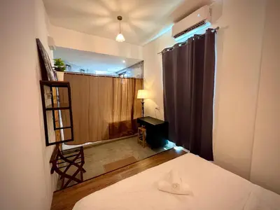 a bedroom with a bed and a room with a window at DoSomething Guest House 8 in Ipoh