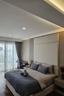 a bedroom with a large bed with a stuffed animal on it at Deluxe Seaview Suite King Bed by The Only Bnb in Tanjong Tokong