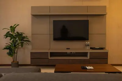 a living room with a television on a wall at Deluxe Seaview Suite King Bed by The Only Bnb in Tanjong Tokong