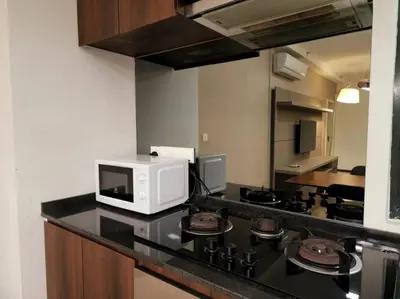 a kitchen with a microwave and a stove top oven at Deluxe Seaview Suite King Bed by The Only Bnb in Tanjong Tokong