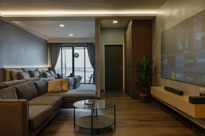 a living room with a couch and a tv at Luxury Seaview Projector Lounge by The Only Bnb in Tanjong Tokong