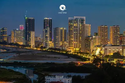 a view of a city at night with a city skyline at Luxury Seaview Projector Lounge by The Only Bnb in Tanjong Tokong
